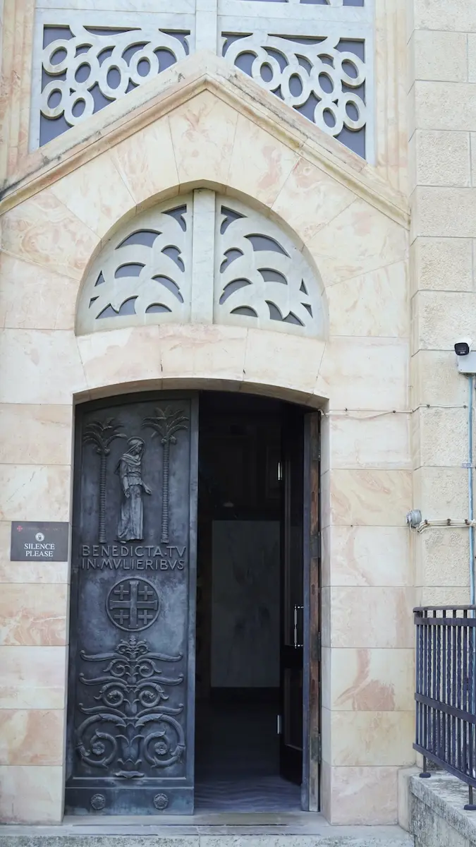 Entrance door of Church of the Visitation — Benedicta tu in mulieribus
